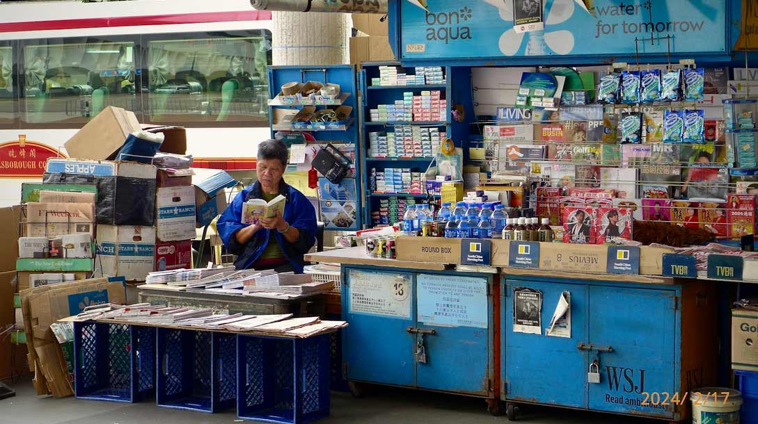 retail store owner recording sales on books manually